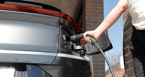 An electrical vehicle charger being plugged in